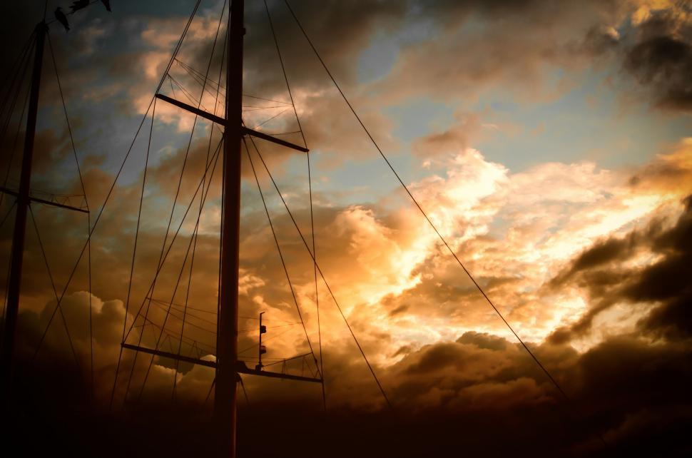 Free Image of Sailboat Floating on Water Under Cloudy Sky 