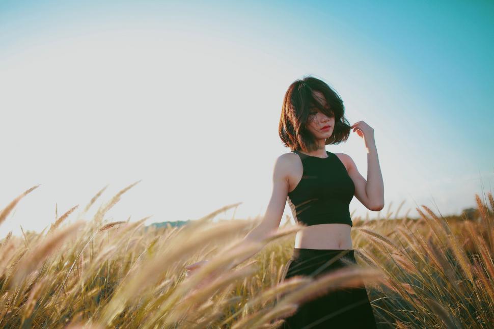 Free Image of Woman Standing in Field of Tall Grass 