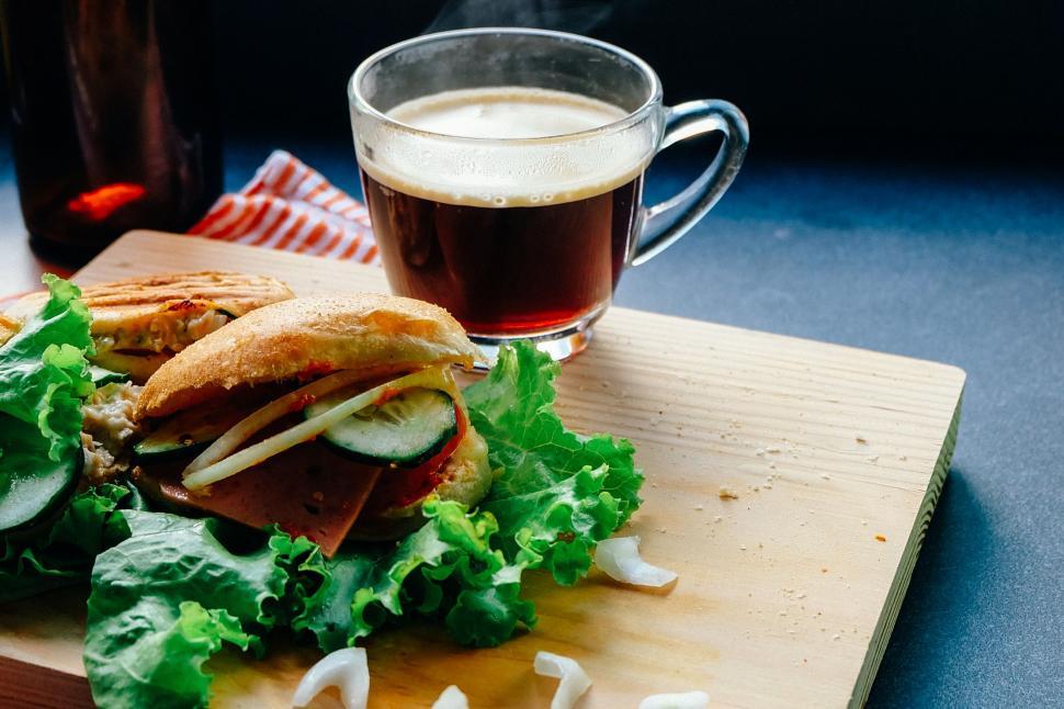 Free Image of Wooden Cutting Board With Sandwich and Cup 