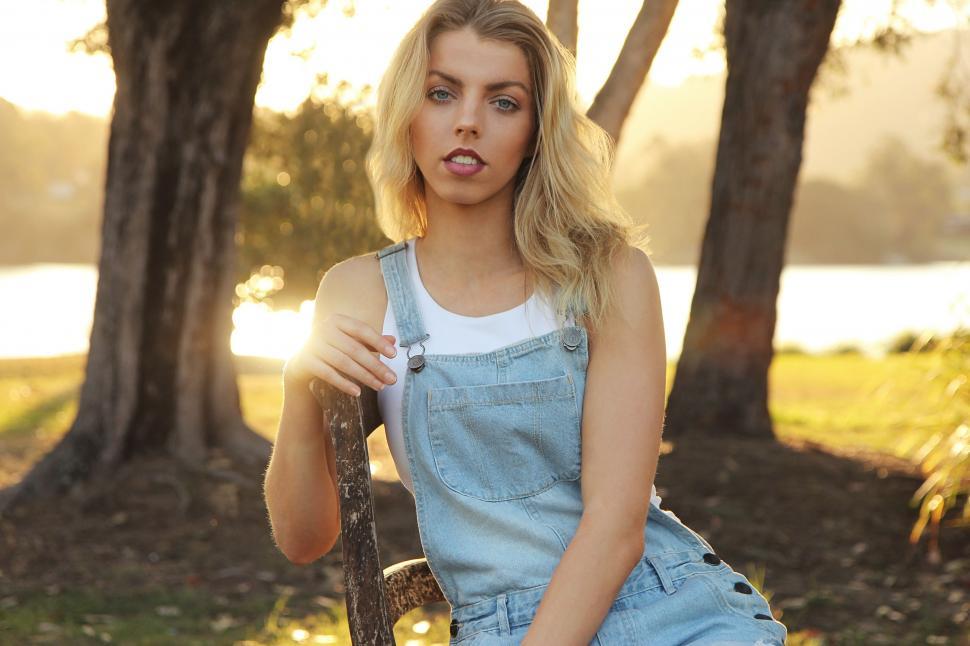 Free Image of Woman Sitting on Bench in Park 