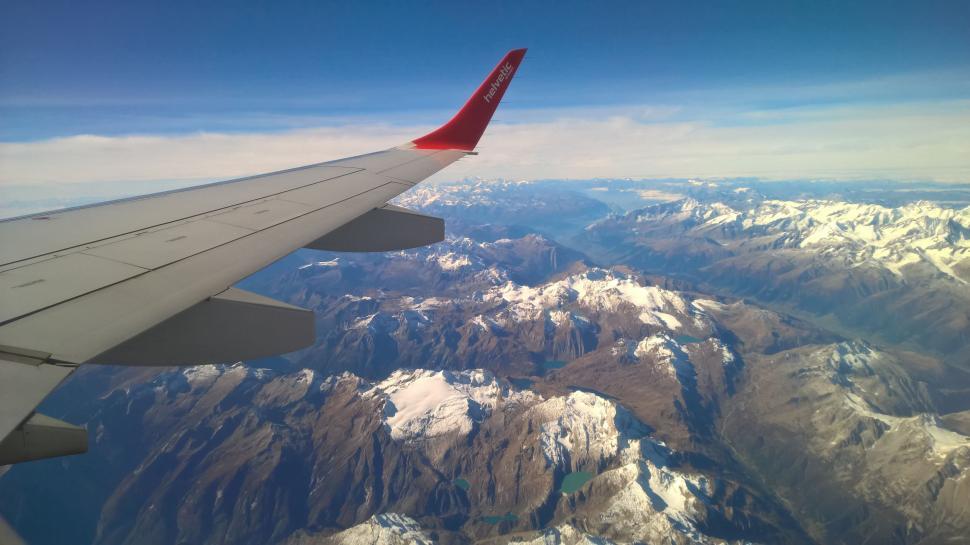 Free Image of Airplane Wing Flying Over Mountain Range 