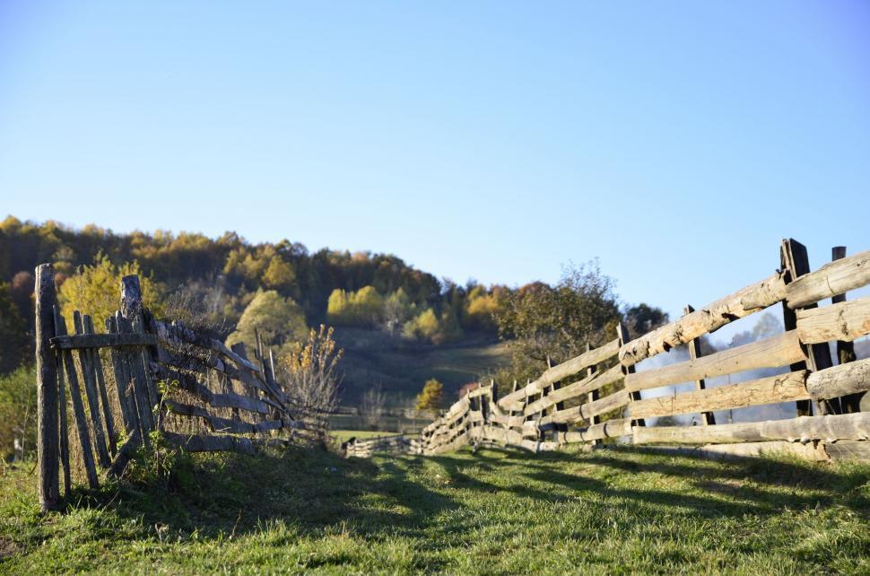 Free Image of Wooden Fence in Grassy Field With Trees 