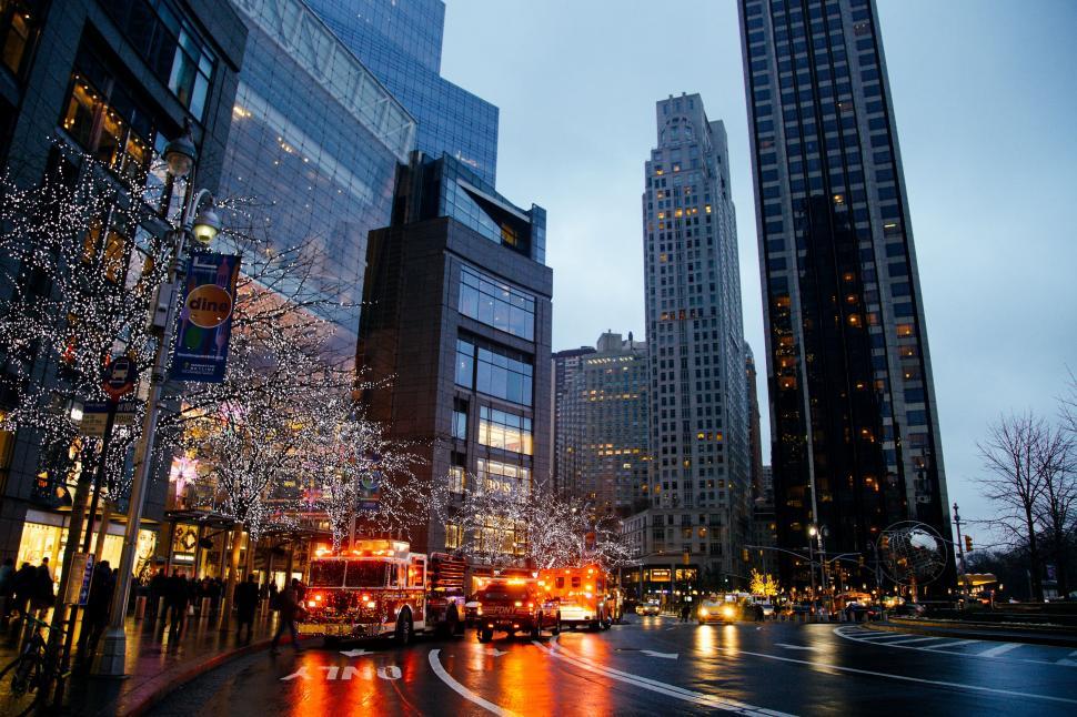 Free Image of Fire Truck Driving Down Busy City Street 