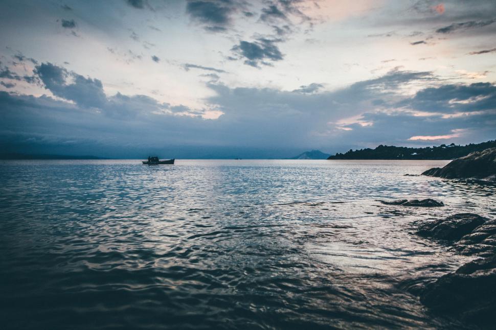 Free Image of Boat Floating on Large Body of Water 