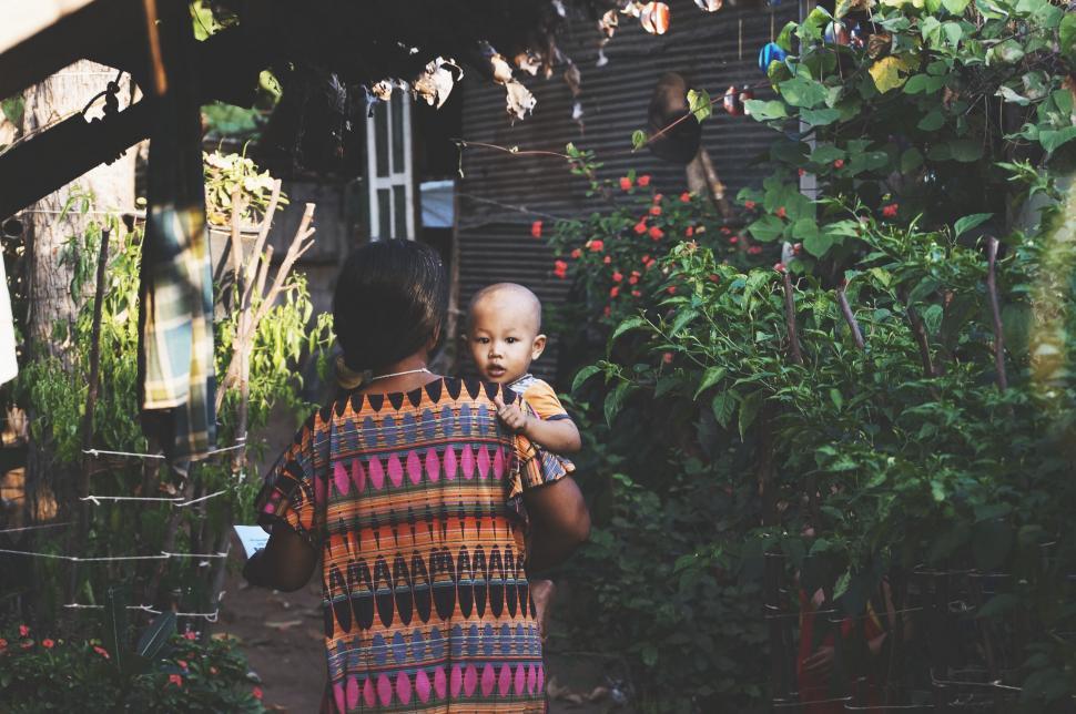 Free Image of Woman Holding Baby in Her Arms 