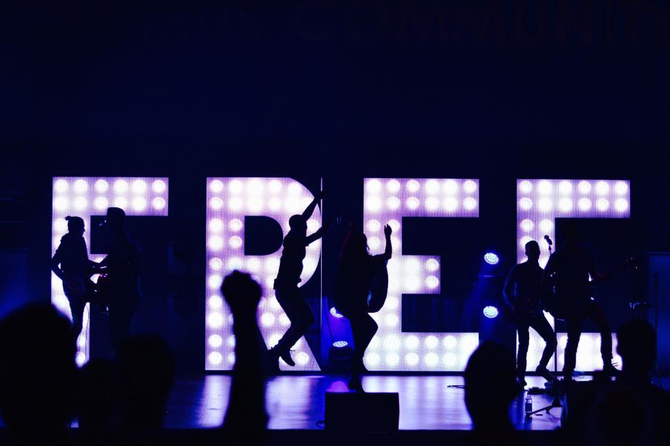 Free Image of Group of People Standing on Top of a Stage 