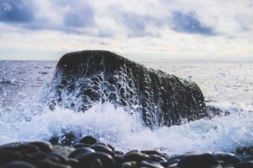Free Image of Large Rock Protruding From Ocean 
