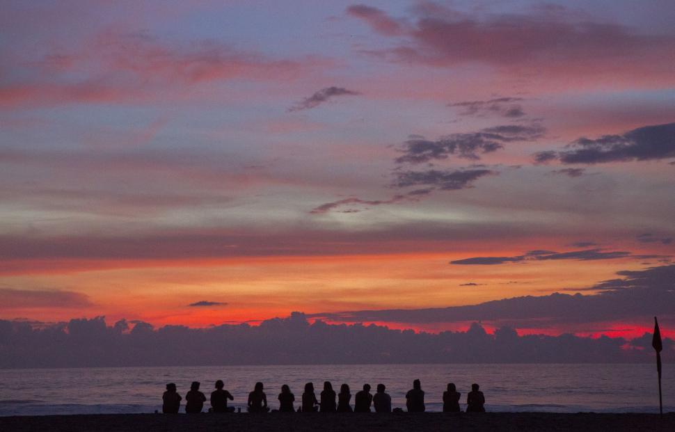 Free Image of Group of People Standing on Top of Beach 