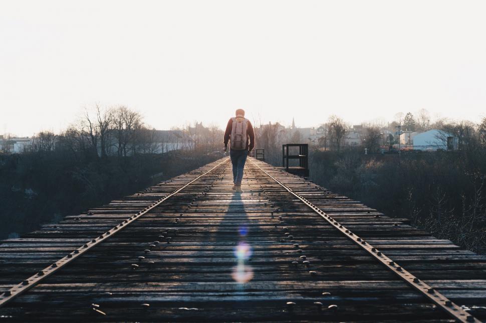 Free Image of Man Walking Across Train Track Towards Camera 