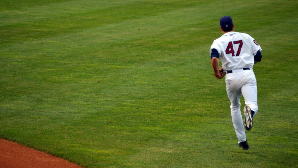 Free Image of Baseball Player Running Across Baseball Field 