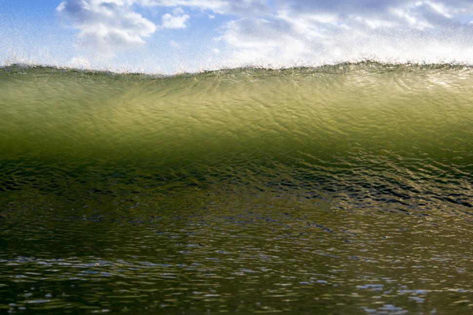 Free Image of Man Riding Wave on Surfboard 