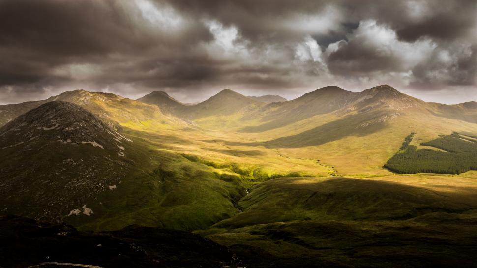 Free Image of Mountain Range Under Cloudy Sky 