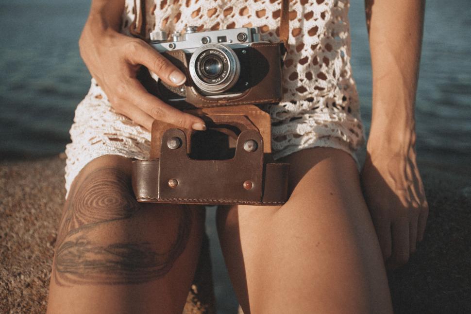 Free Image of Woman Holding Camera by Water 