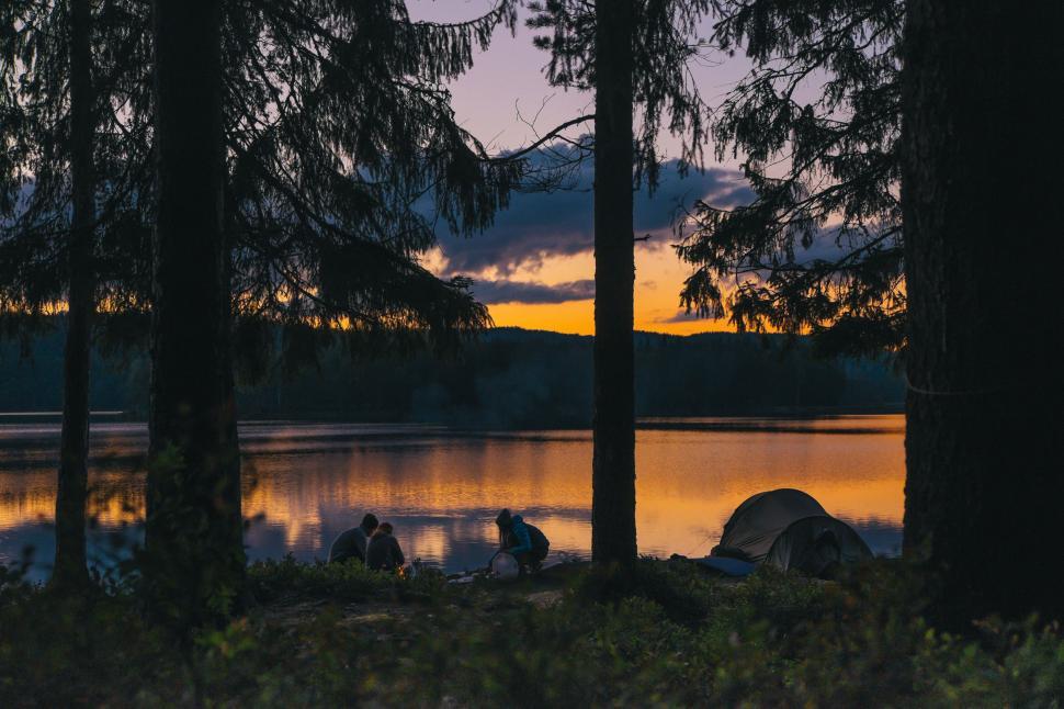 Free Image of People Sitting by Lake 