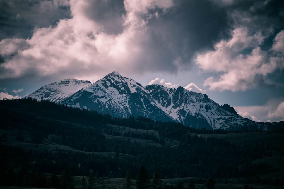 Free Image of Snow Covered Mountain Under Cloudy Sky 