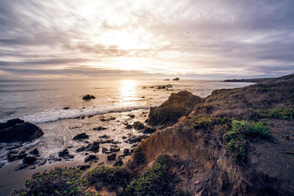 Free Image of Sun Setting Over Ocean, Beach Scene 