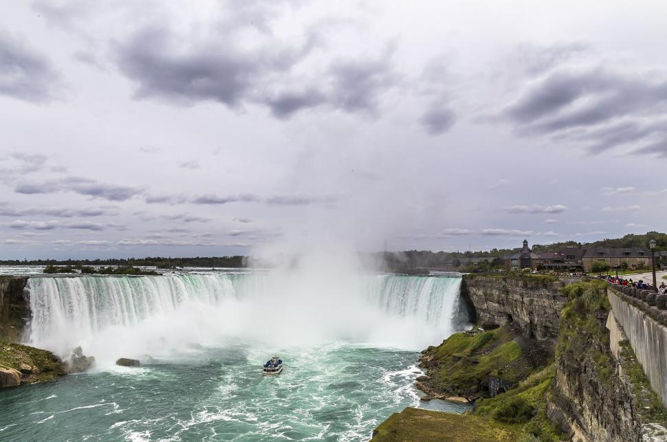 Free Image of Boat Sailing Near Waterfall 