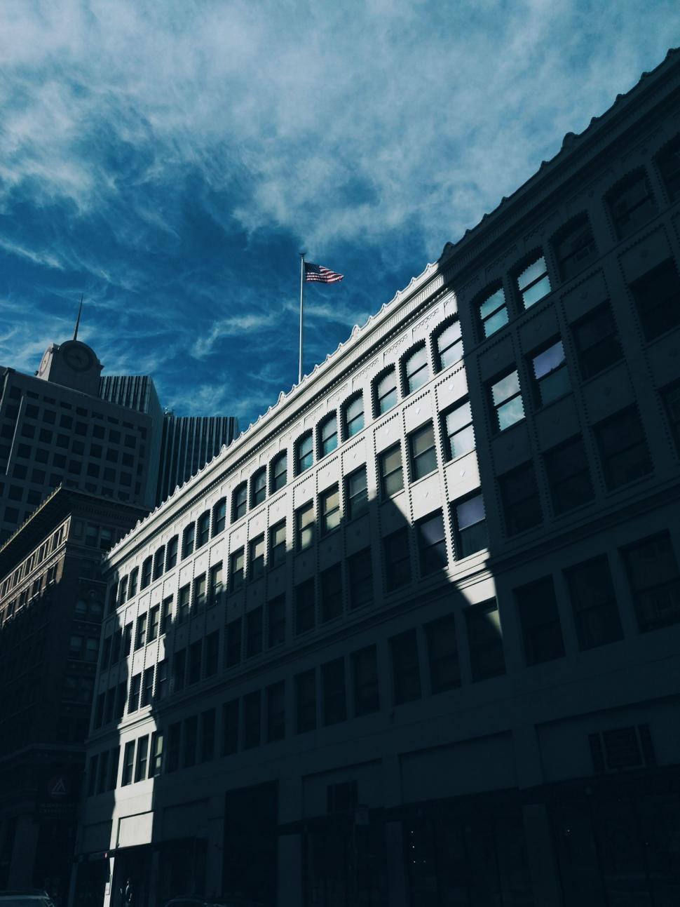 Free Image of Tall Building With Flag on Top 
