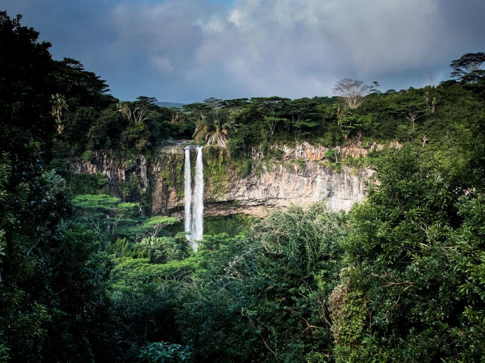Free Image of Majestic Waterfall in Lush Green Forest 