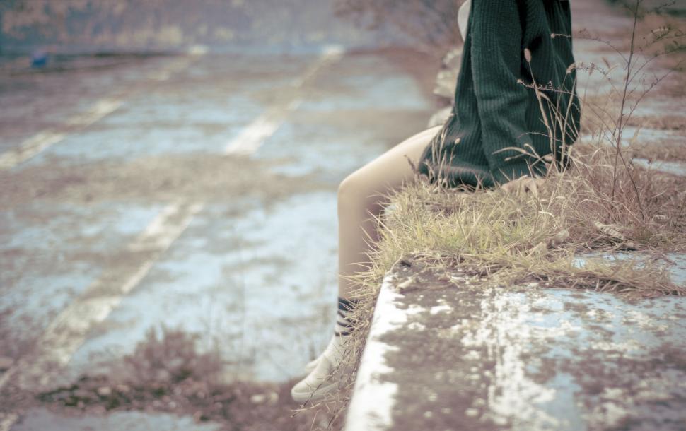 Free Image of Person Sitting on Bench in Rain 