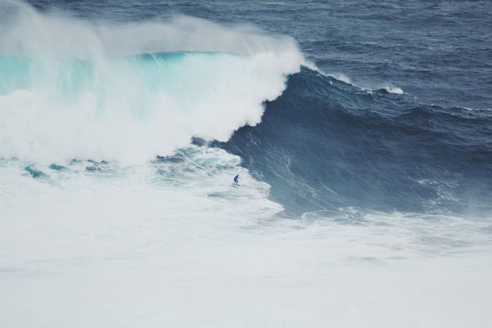 Free Image of Man Riding a Wave on a Surfboard 