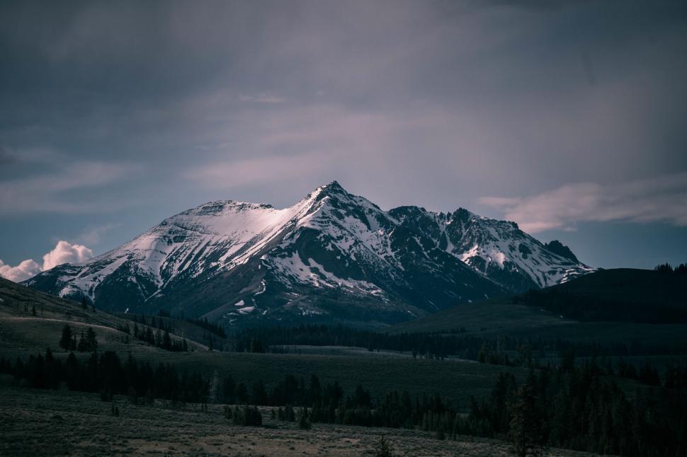 Free Image of Snow Covered Mountain Under Cloudy Sky 