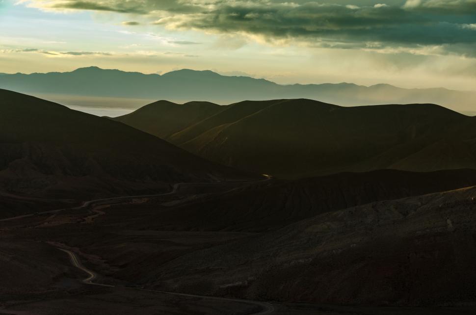 Free Image of Cloudy Sky Over Mountain Range 