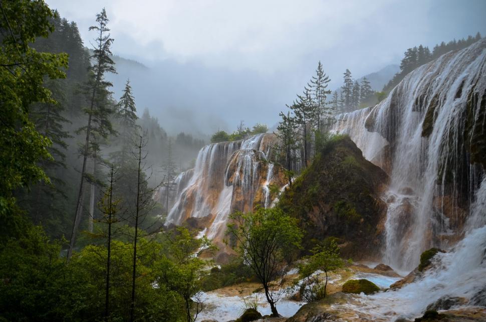 Free Image of Majestic Waterfall in Lush Forest 
