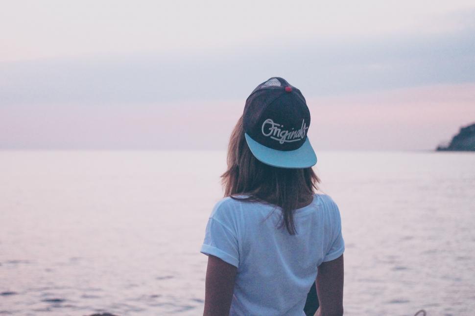 Free Image of Person Standing on Beach With Hat On 