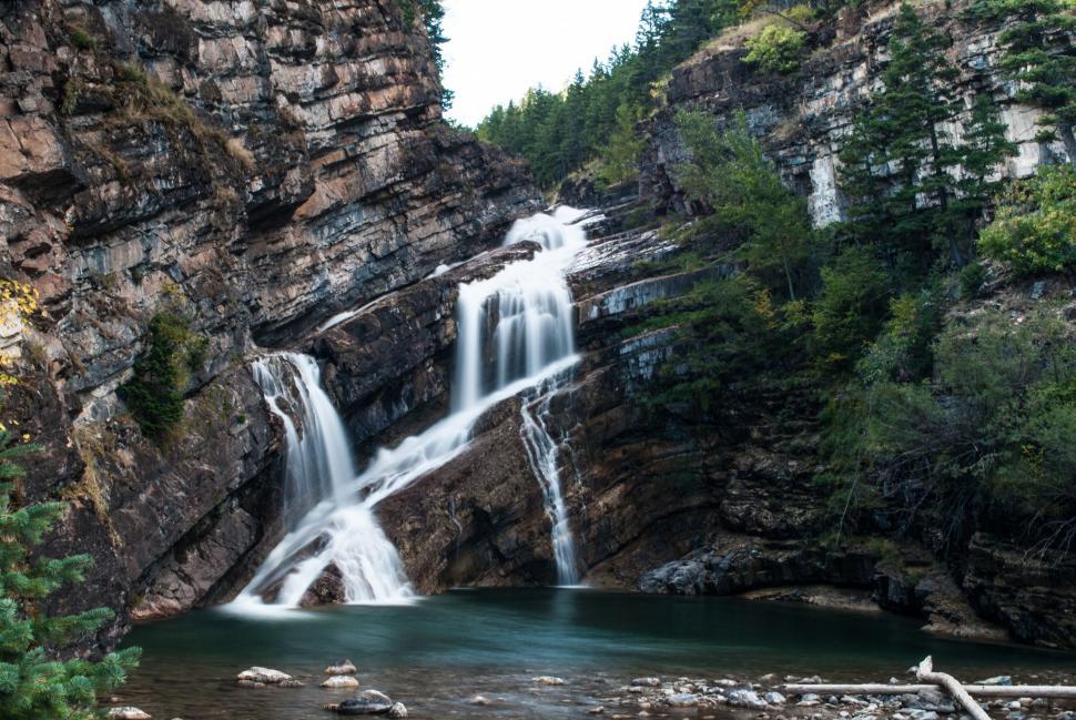 Free Image of Waterfall Flowing Through Dense Forest 