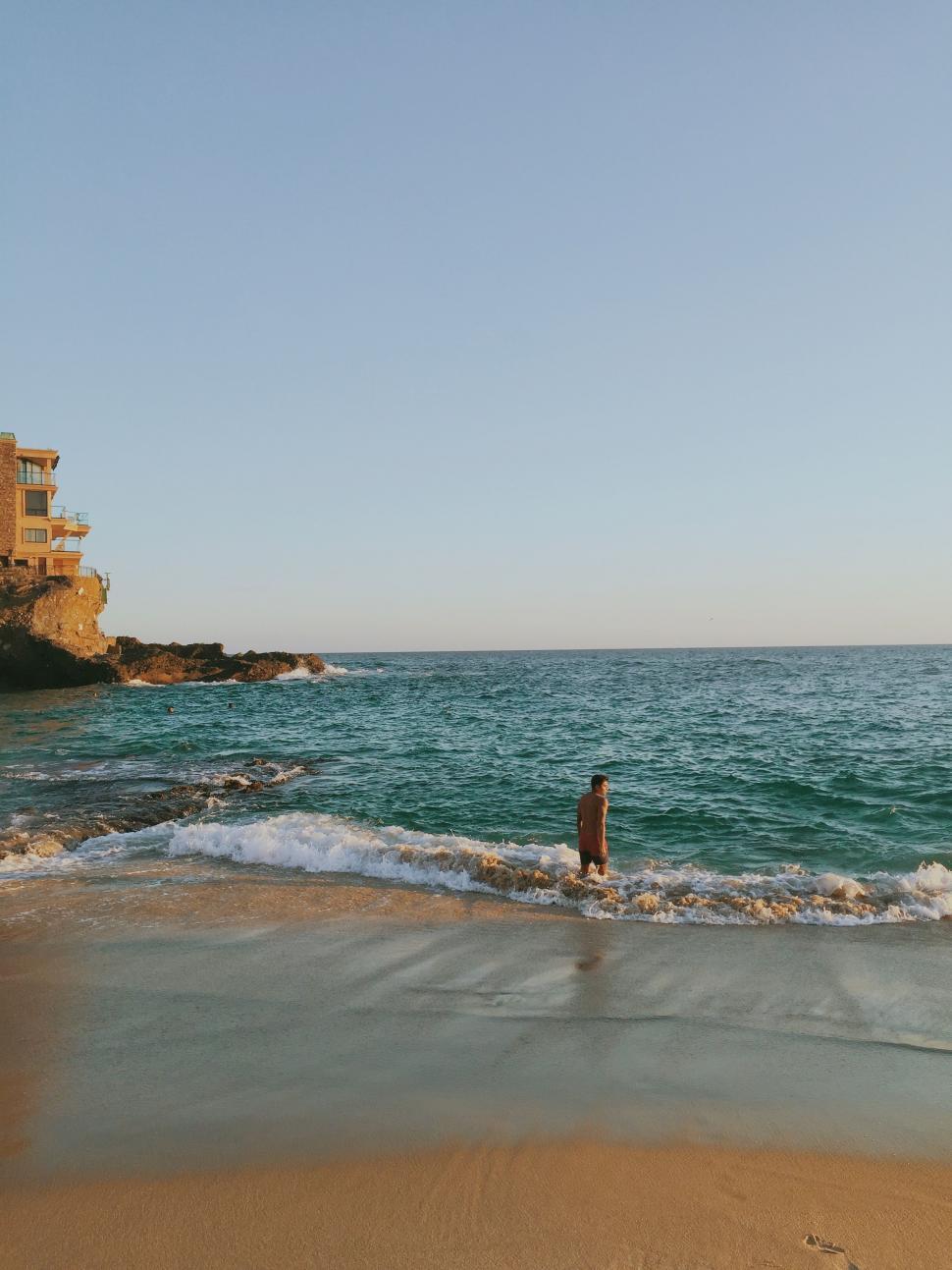 Free Image of Person Standing in Water at Beach 