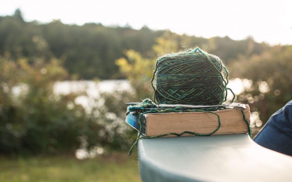 Free Image of Ball of Yarn on Book 