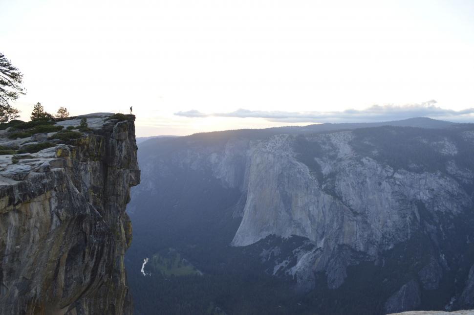 Free Image of Man Standing on Top of Cliff 