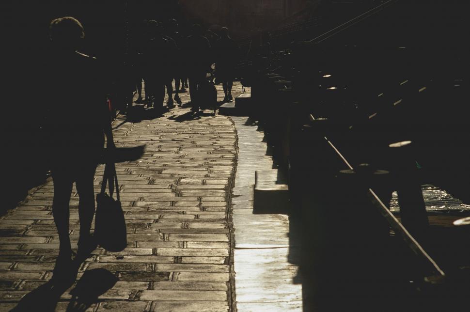 Free Image of People Walking Down Sidewalk 