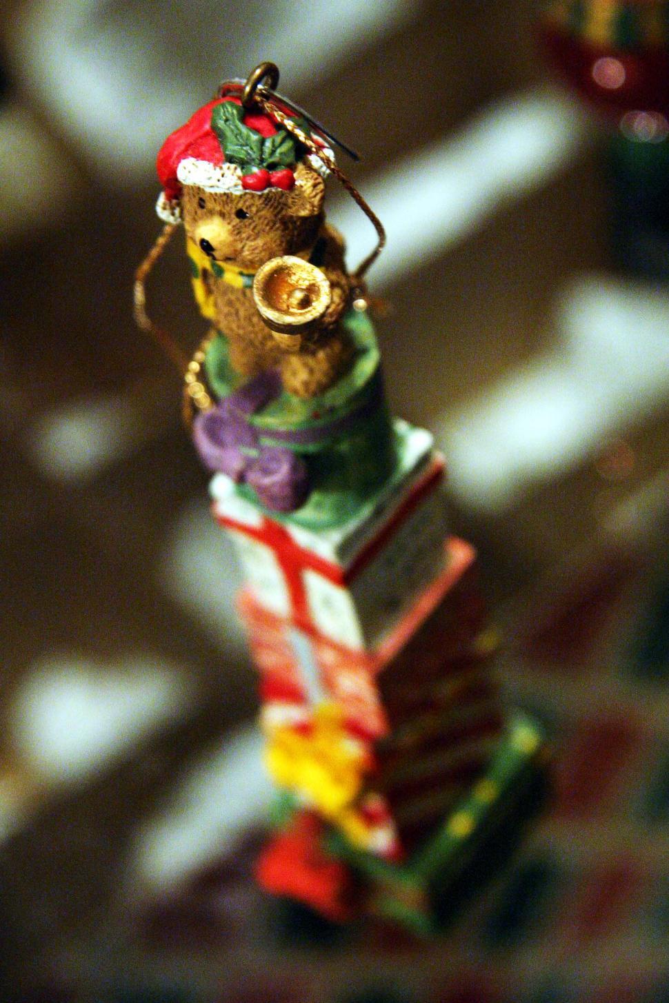 Free Image of Teddy Bear Sitting on Top of Stack of Books 