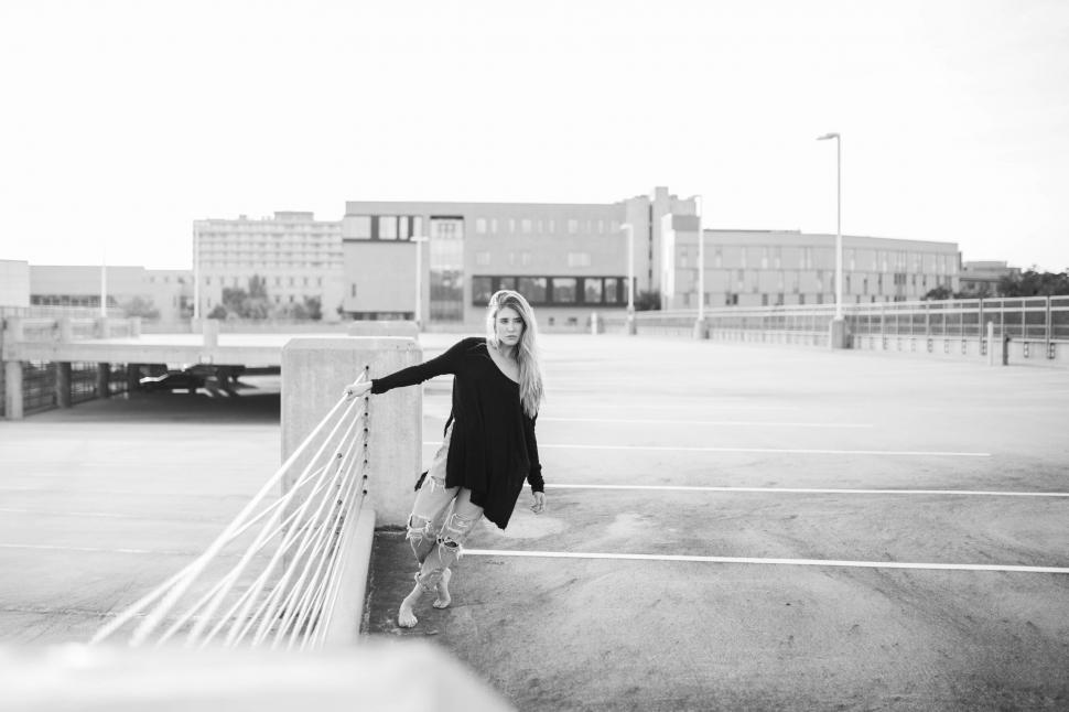 Free Image of Woman Standing at Tennis Court Next to Fence 