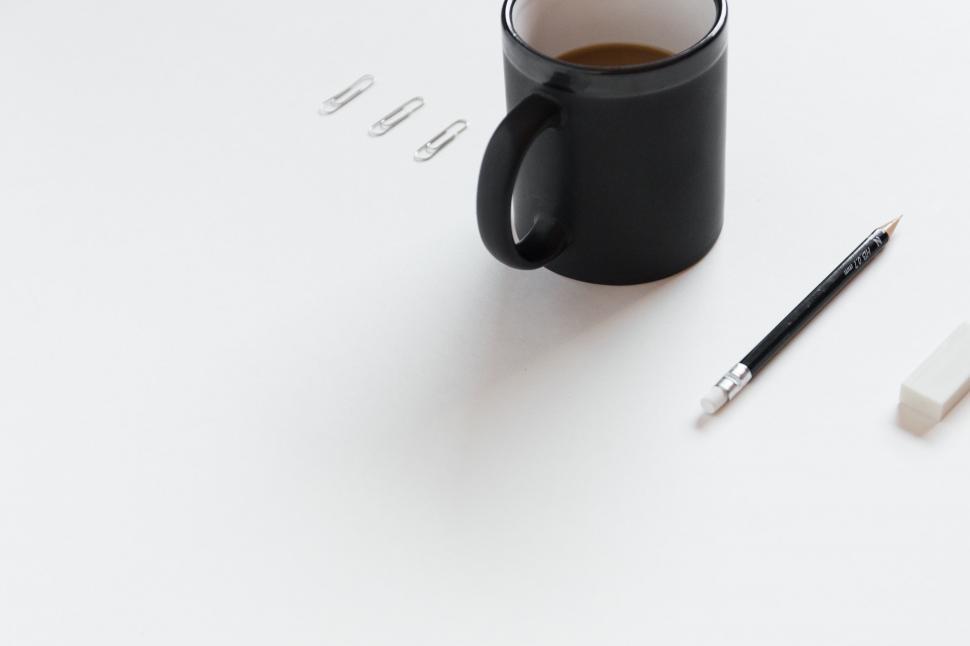 Free Image of A Cup of Coffee and a Pen on a Table 