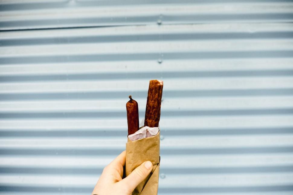Free Image of Person Holding a Piece of Food in Hand 