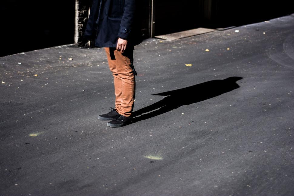 Free Image of Man Standing in the Middle of a Street 