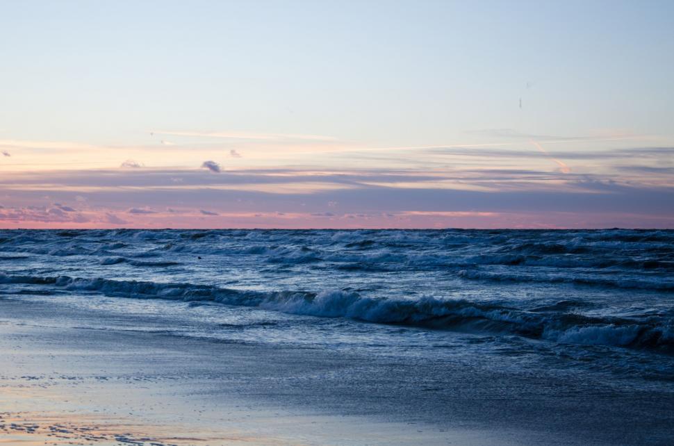 Free Image of Person Walking on Beach With Surfboard 