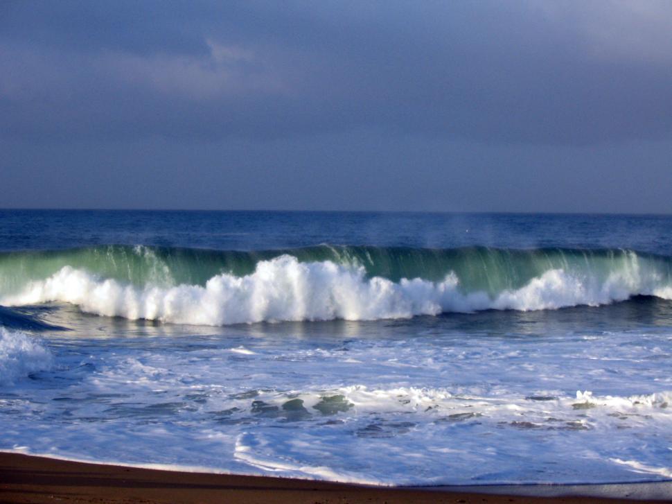 Free Image of Man Riding Wave on Surfboard 