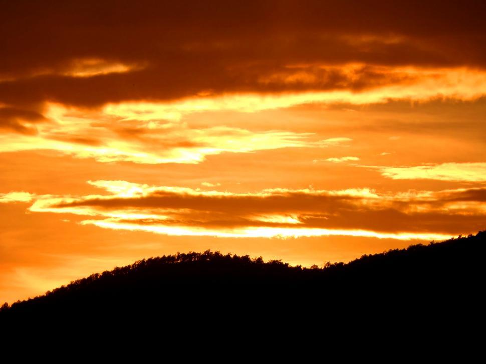 Free Image of sunset sky over silhouetted hills  