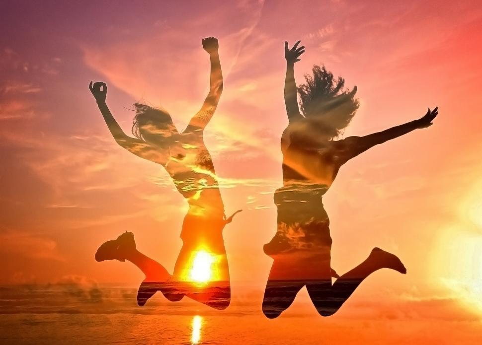 Free Image of Two Girls Cheering on the Beach - Double Exposure Effect 