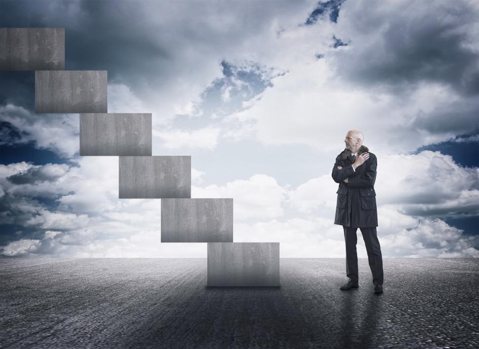Free Image of Man having doubts facing a staircase 