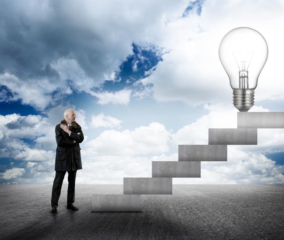 Free Image of Businessman facing stairs with lightbulb 