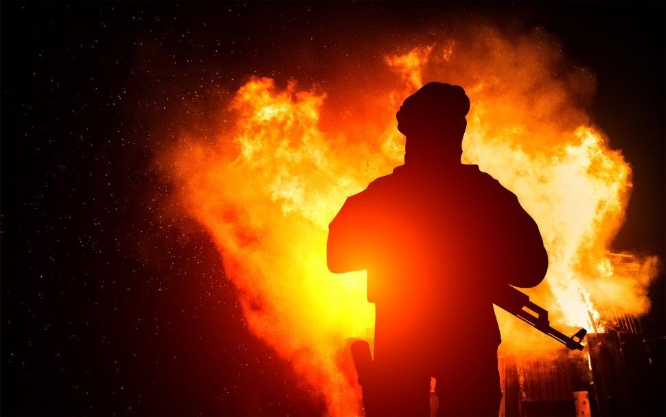 Free Image of Armed Man with Background Explosion 