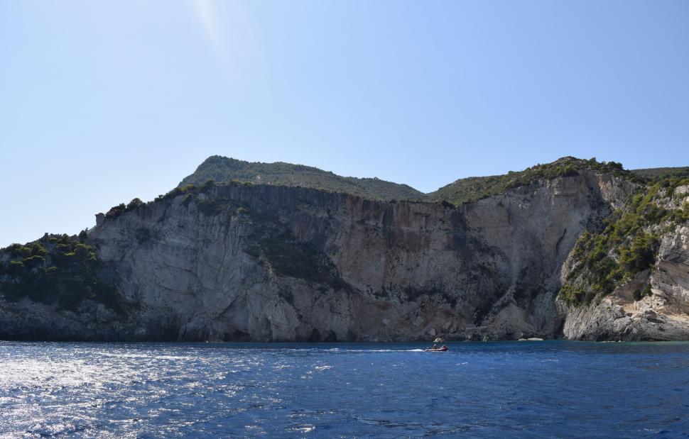 Free Image of Rocky shoreline and boats of the Mediterranean Sea in Greece  