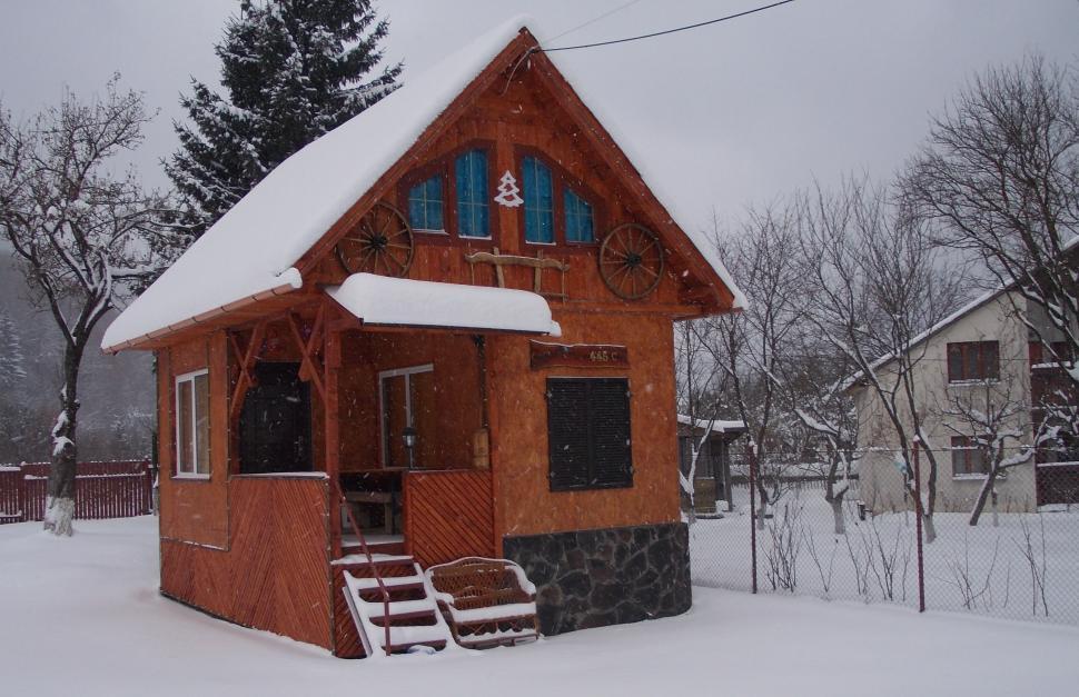 Free Image of Small demonstration stone and wooden rural house covered in snow  