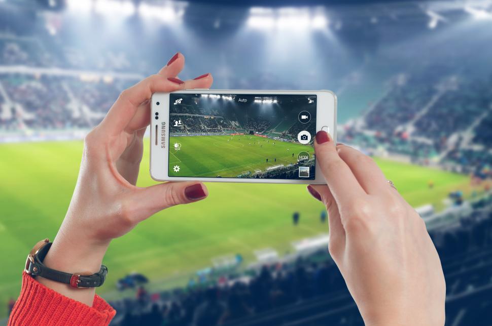 Free Image of Hands holding a phone taking video 