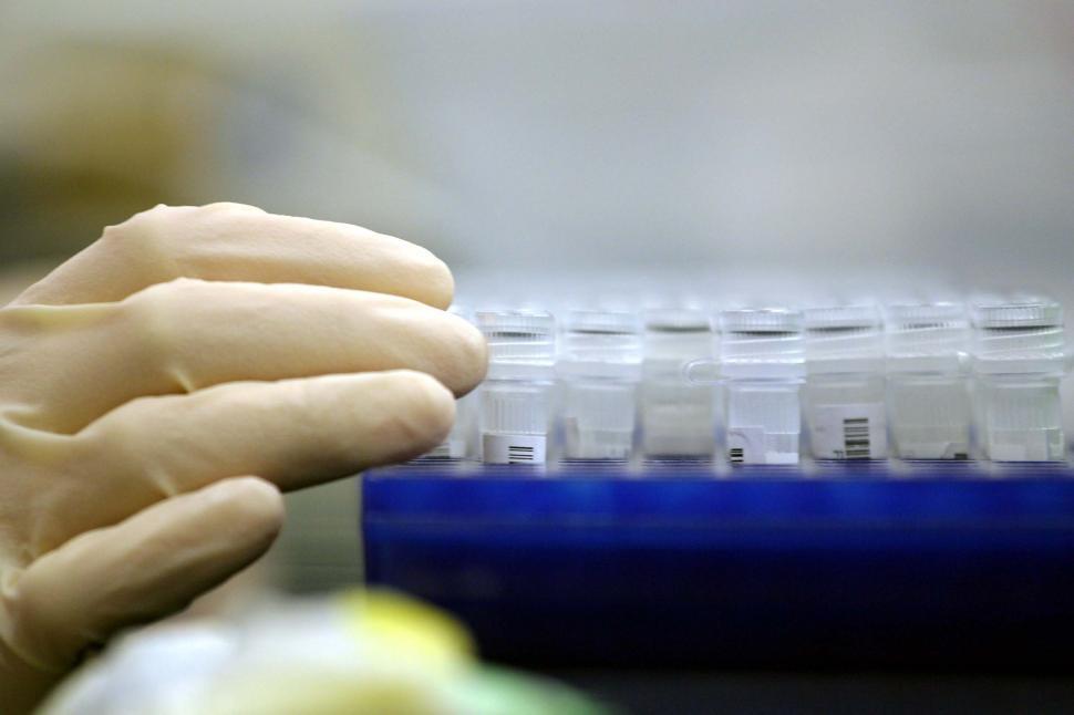 Free Image of Technicial with sample tubes 